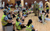 Ancient Greeks vs Victorians Primary school students have made an amphitheatre by sitting on stools, some participants are wearing masks and fabric pretending to be actors on stage.