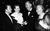 A black and white image of Richard Attenborough and Sheila Sim with Peter Saunders and Agatha Christie