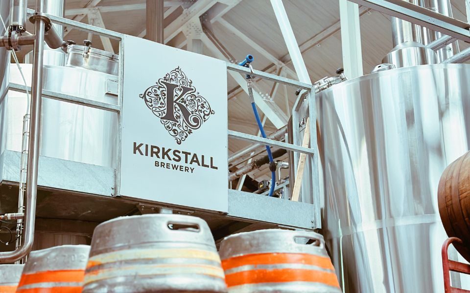 An image of the interior of Kirkstall Brewery, their logo showing in front of a set of brewing tanks. Credit: Aaron Cawood