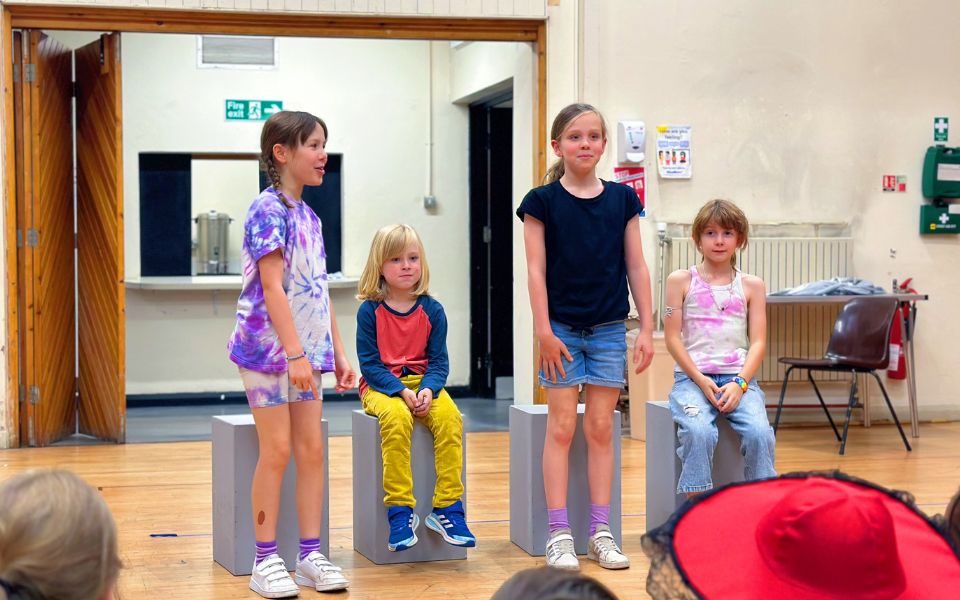 A group of young people perform to an audience. Credit: Aaron Cawood