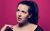 Rosie Jones Rosie Jones looking off to the side thoughtfully in front of a pink background