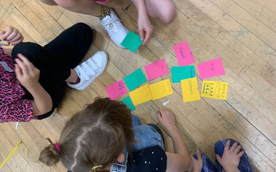 Young people organise words written on cards to make a poem.