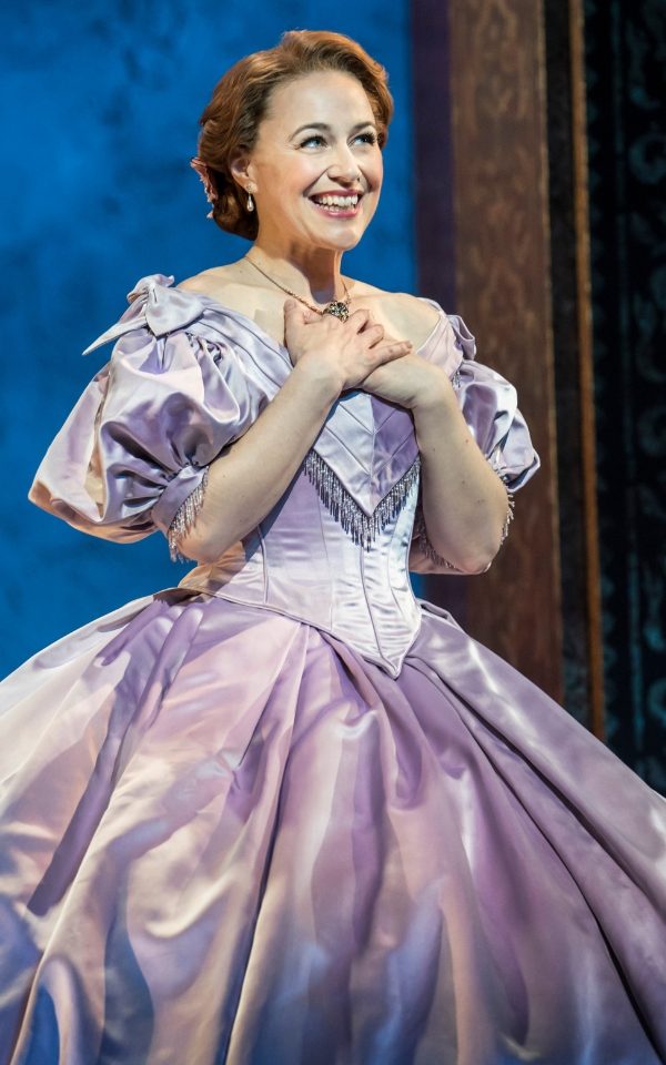 Annalene Beechey as Anna Leonowens in a lilac ballgown with her hands folded on her chest.