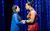 The King and I Marienella Phillips and Dean John-Wilson in The King and I. The hold hands and look into each others' eyes. She wears a blue robe and he wears traditional red Thai clothing.