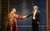 The King and I Darren Lee and Sam Jenkins-Shaw in The King and I. Darren wears a red and gold robe and shakes hands with Sam in a black suit and bowtie.