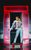 Everybody's Talking About Jamie Jamie is wearing a jean jacket and jeans. He has his hair up and is wearing bright red heels. He is walking out of a red-lit doorframe.