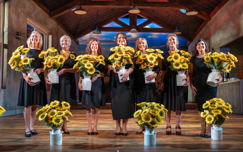 The Calendar Girls with their sunflowers.