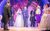 I Should Be So Lucky A bride in a wedding dress walking down the aisle with a man in a suit surrounded by wedding guests.