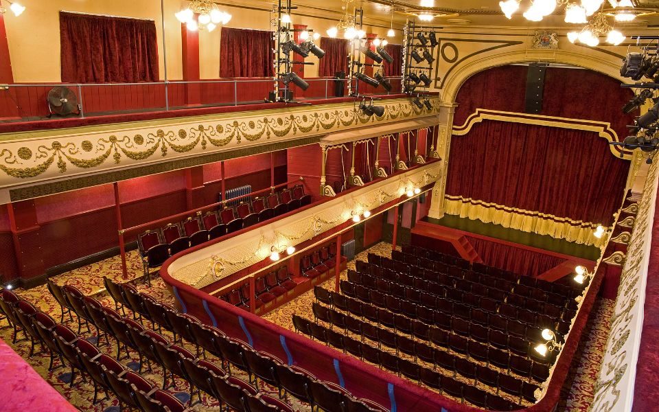 City Varieties auditorium taken from the Upper Circle right. Gold paintwork, red seats and stage.