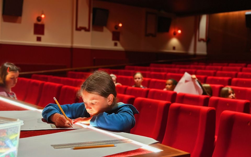A child drawing in the auditorium at Hyde Park Picture House