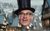 Count Arthur Strong The head of Count Arthur Strong wearing a black top hat and glasses with a snowy Victorian street in the background.