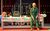Drop The Dead Donkey A woman in a green boiler suit leaning against a desk 'Well Done Team'.