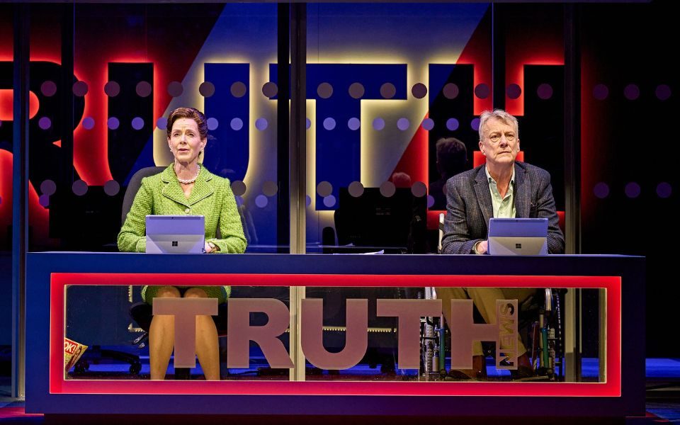 Two newsreaders at a desk with the word TRUTH on it.