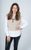 Gaynor Faye Gaynor Faye in a white shirt and beige jumper smiling at the camera with her hand on her hip