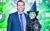 Chris Blythe with Amy Webb as Elphaba Chris Blythe in a suit smiling at the camera with Amy Webb dressed in a black witch outfit as Elphaba from Wicked in front of the Wicked press board.