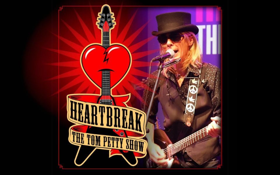 Graphic of a v-shaped electric guitar puncturing a heart accompanied with an image of a performer playing a black electric guitar with text on a banner wrapped around the graphic guitar reading Heartbreak The Tom Petty Show.