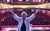 Jan Hunt Jan Hunt with her arms out-stretched standing on the City Varieties stage with the auditorium in the background
