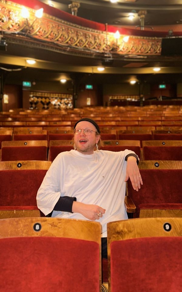 Henry gazes into the distance in the auditorium of Leeds Grand Theatre