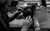 Harriet Rogers A black and white photo of Harriet Rogers fixing a wig in the wigroom.