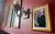 A signed photograph of Henning Wehn in City Varieties Circle Bar A signed framed photograph of Henning Wehn holding a replica of the football World Cup in the Circle Bar from 2017 on the wall in Circle Bar. Wall lamps and framed posters appear in the background.