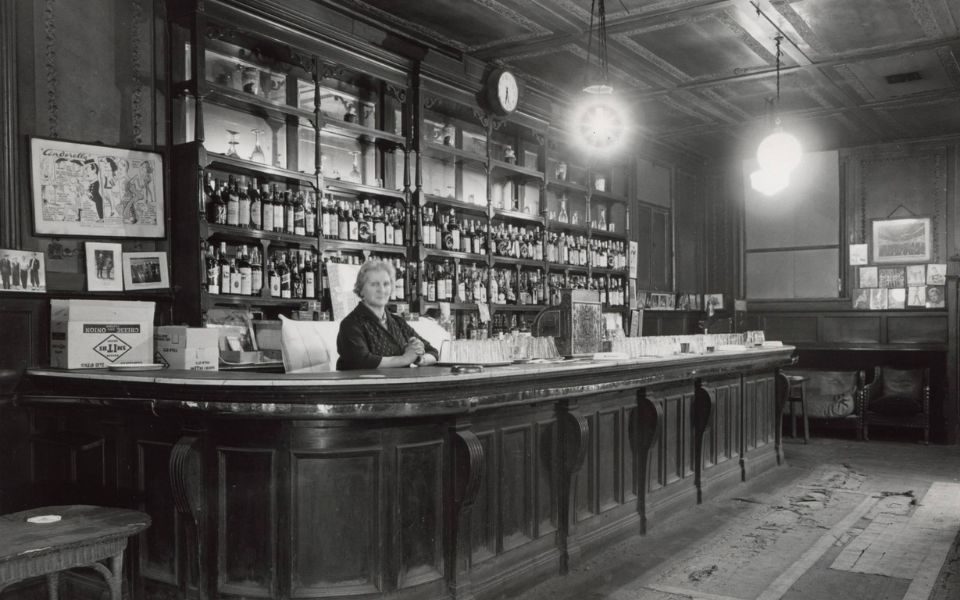 Black and white image from 1963 of a woman stood at the City Varieties Circle Bar.