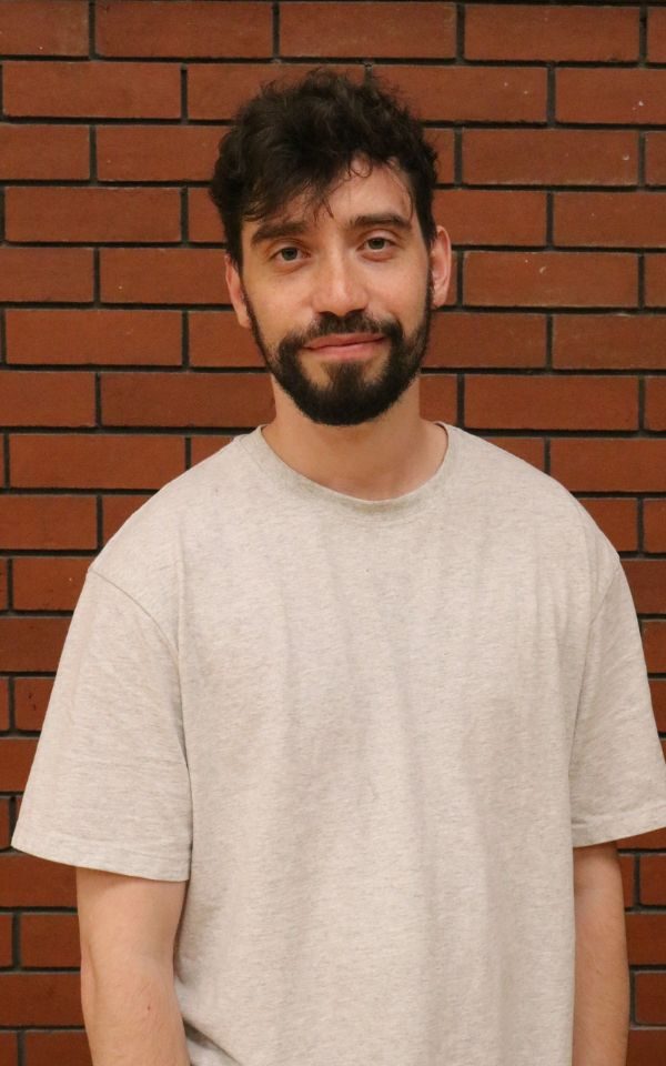 An actor poses for his headshot in a white t-shirt