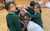 Tableau exercise. A large group of primary schoolchildren in uniform hold position in a drama tableau smiling.