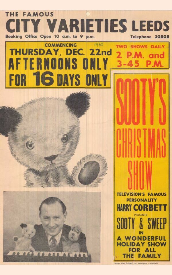 City Varieties programme from Sooty's Christmas Show in 1957 featuring a large illustrated image of Sooty the bear's head and black ears with a photo of Harry Corbett holding up hand puppets Sooty and Sweep the dog in front of a small keyboard. Text reads: The Famous City Varieties. Booking Office Open 10am to 9pm. Telephone 30808. Commencing Thursday Dec. 22nd Afternoons only for 16 days only. Two shows daily. 2pm and 3.45pm. Sooty's Christmas Show. Television's famous personality Henry Corbett presents Sooty and Sweep in a wonderful holiday show for all the family.