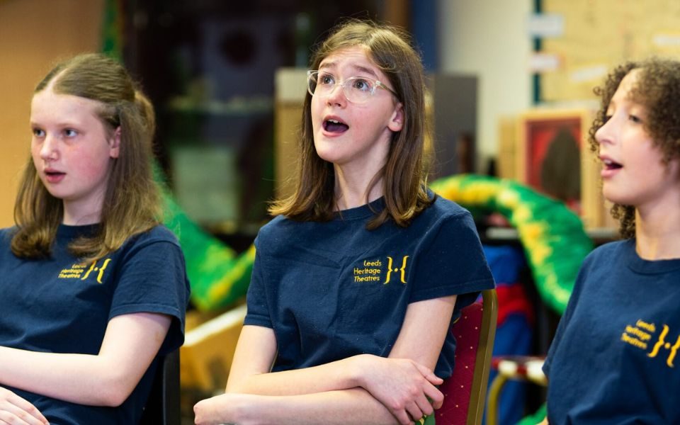 Three members of LGYT sit singing