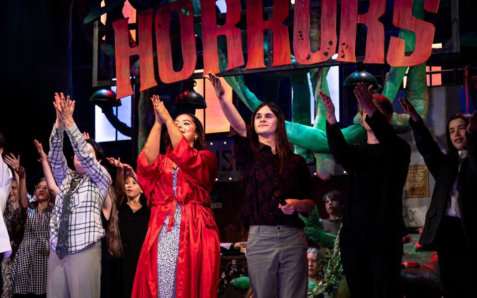 Lottie, Munashe, Sunny and Dan during final bows. Credit Chris Coote The title set pieces of Little Shop of Horrors float behind the cast who applaud during final bows