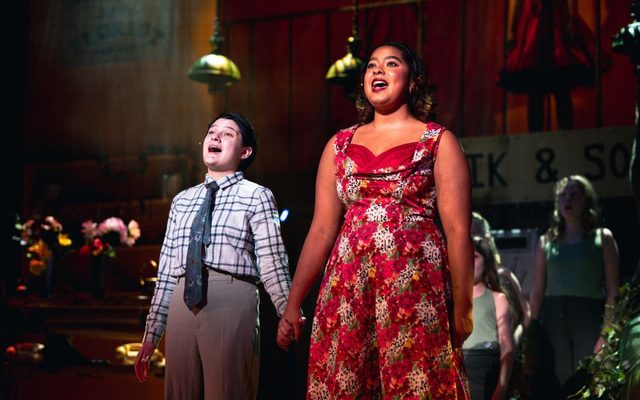 Lottie and Munashe as Seymour and Audrey. Credit Chris Coote Two young actors sing out to the audience, one in a flowery red dress and one in a checked shirt and tie