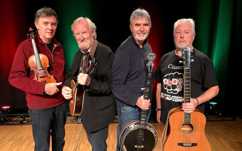 Members of The Dublin Legends pose holding instruments