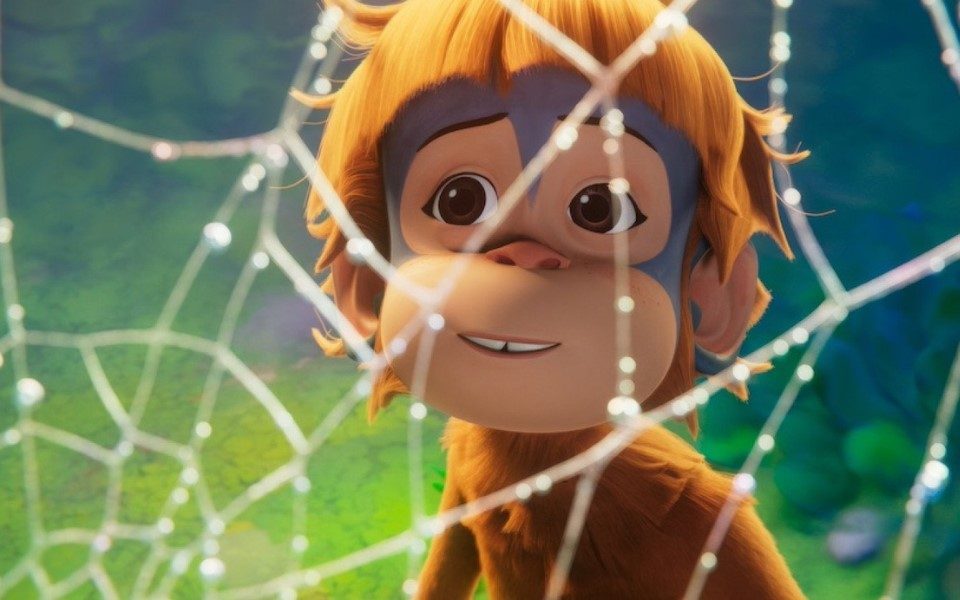 Cartoon baby orangutan behind a blurred sparkling spider's web.