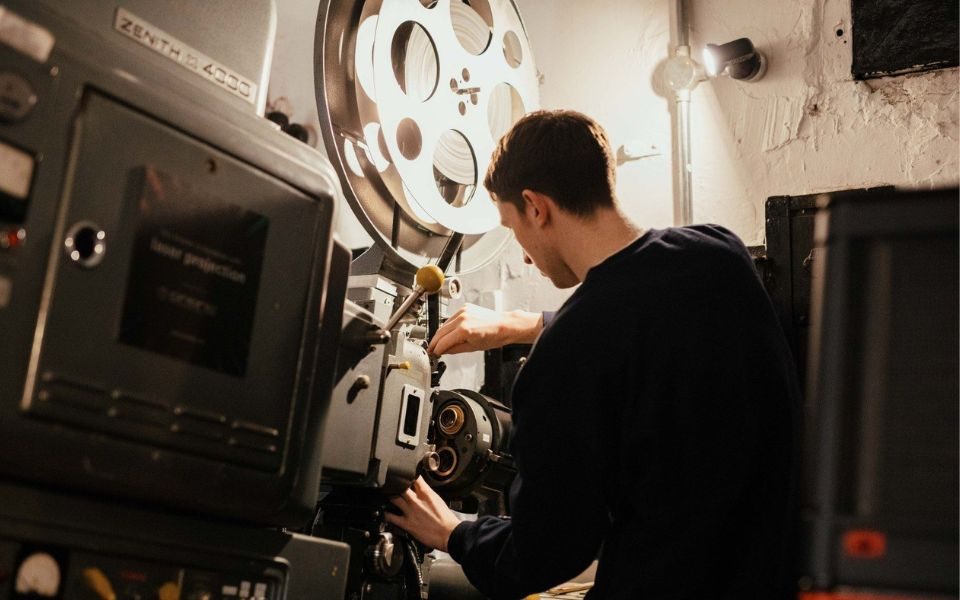 A Hyde Park Picture House projectionist works on a projector.