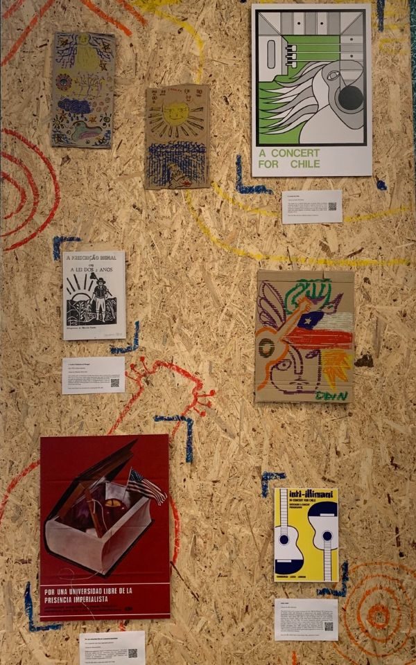 A corkboard of art pieces with descriptive labels