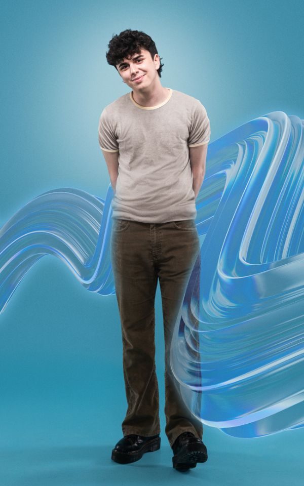 Sonny Monaghan in a grey t-shirt and brown trousers with a blue swoosh around him.