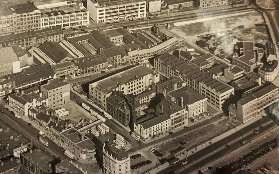 A black and white photo of Leeds city centre from above with the Thorne's factory building visible in the middle of frame