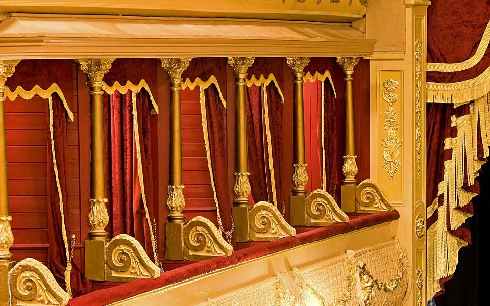 Image of the City Varieties left Boxes taken from the Circle with a bit of the stage curtain appearing in the right of the image.