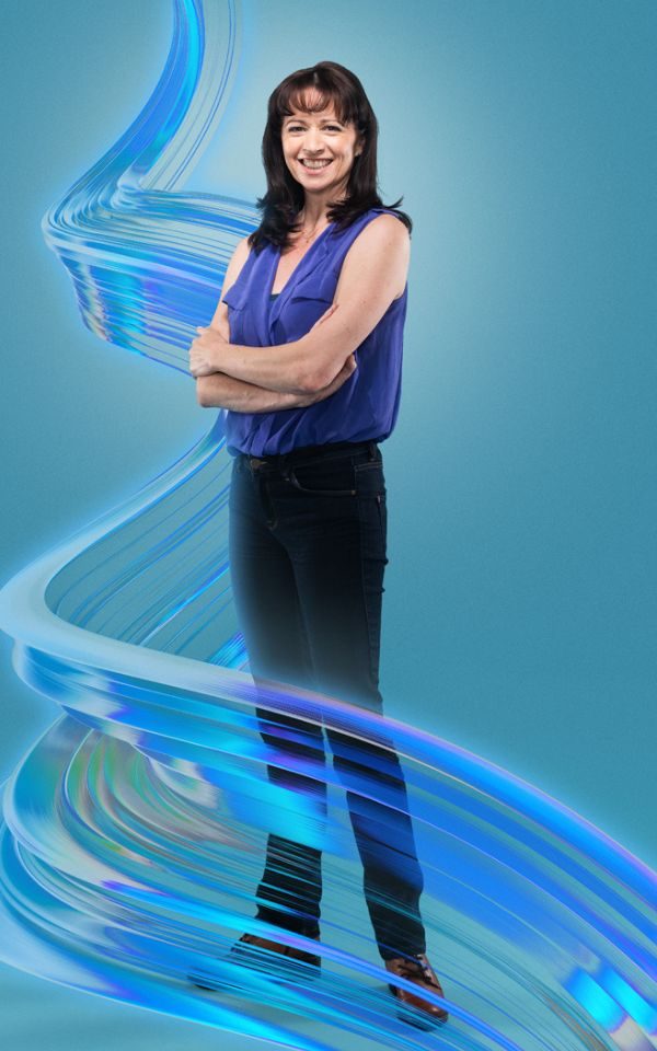 Helen Anker in black trousers and a blue sleeveless top standing with her arms folded against a blue background with a stylized blue swirl around her.