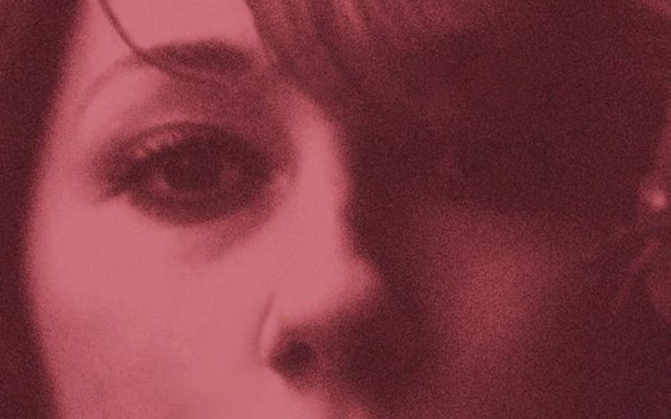 Zoomed in image of the cover of Martha Wainwright's self-titled debut album that features just a low quality image of her face with a pink-toned filter.