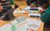Secondary Schools. Credit Aaron Cawood A close up shot of a moodboard on a desk with students faces just visible in the background huddled around the desk