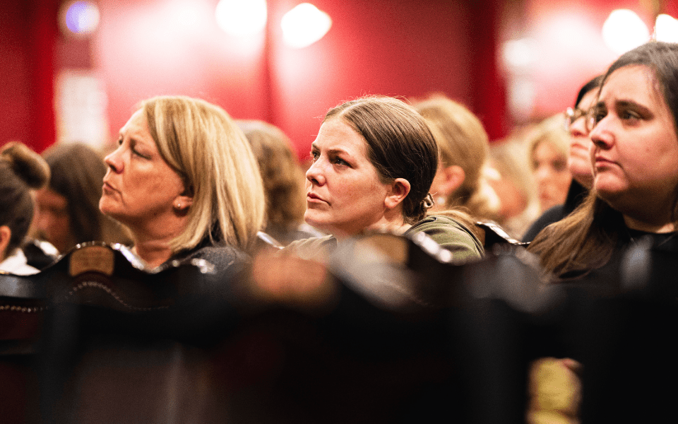 Teachers listening intently in the auditorium at City Varieties