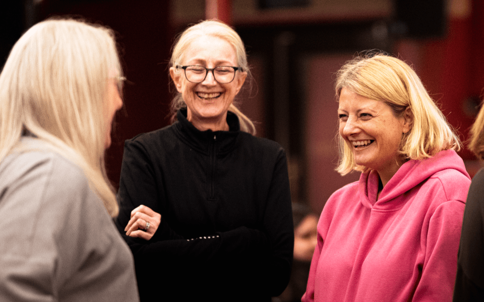 Teachers laughing with each other at City Varieties