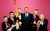 The Horne Section Members of the Horne Section holding their instruments with Alex Horne looking excitedly shocked in the middle