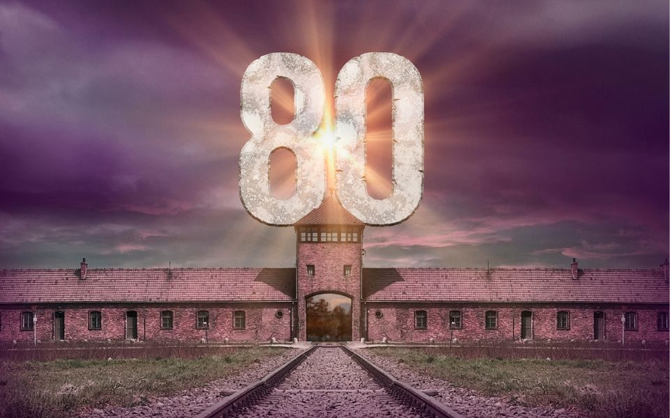 Famous image of a railway track heading for a long brick building at Auschwitz with the number 80 appearing in the sky.