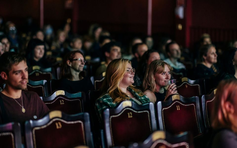 An audience smiling in the City Varieties.