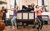 Calamity Jane Rehearsals Carrie Hope Fletcher lies on top of a piano while Theo Diedrick and Emma Jane Morton play the clarinet and flute on either side of her.