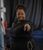 Eleanor Manners A drama facilitator in athletic wear stands and points towards the camera while smiling