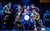 Only Fools and Horses: The Musical The cast of Only Fools and Horses: The Musical grouped together staring off thoughtfully wearing period-accurate costumes. The man in the middle wears a blue suit and holds a white ball. One character leans in, smoking.