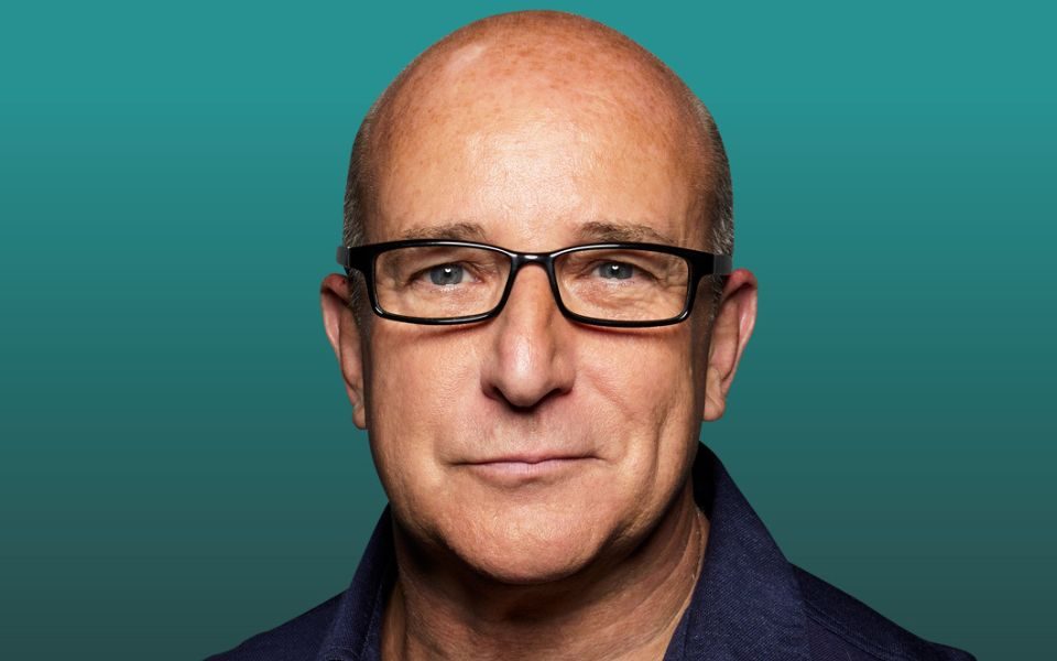 Image of Paul McKenna from the shoulders up wearing glasses.